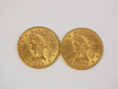 two gold coins, one of which has a woman ' s head and one of which is a man '