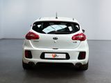 the rear end of a white car in a white room