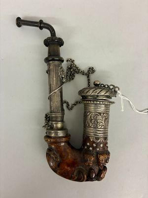 a pipe with a chain attached to it on a wall
