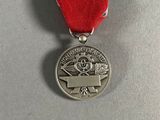 the medal is placed on the table with a ribbon around it