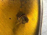 a close up of a metal object with a hole in it