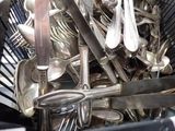a basket full of silver spoons and spoons in it