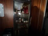a small refrigerator with a lot of bottles of wine in it