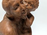 an image of a statue of a man holding a baby
