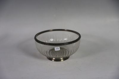 a small glass bowl with a black rim on a white surface