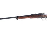 a rifle with a wooden barrel on a white background
