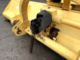 a close up of a yellow machine with a chain attached to it