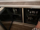 a person that is standing in front of a wine cooler
