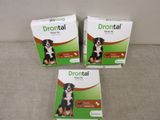 three boxes of drontal for dogs sitting on a couch