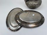 a silver plate and a silver bowl on a white table