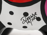 a close up of a black and white cat with polka dots on it