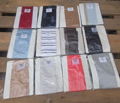a lot of different colored shirts on a wooden table