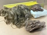a pile of hair sitting on a table next to a box