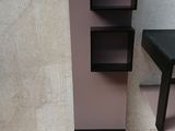 a black and purple shelf next to a black table