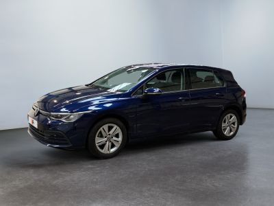 the blue car is parked in a room with a white wall