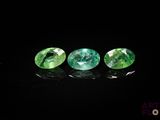 trois tourmalines vertes sur un fond noir