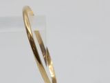 a close up of a gold ring on a clear surface