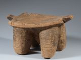 an old wooden stool with two legs and a seat made of wood