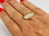 an image of a woman ' s hand with red nails and a gold ring