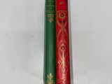 two red and green books sitting next to each other on a white surface