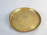 a gold plate with a white background on the table