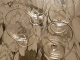 four wine glasses sitting on a marble table