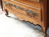 a wooden dresser with a mirror on top of it