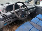 dashboard of a car with blue seats and a steering wheel