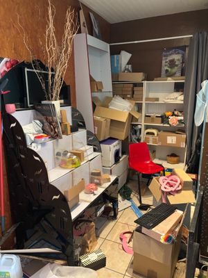 a room with a lot of clutter and boxes on the floor