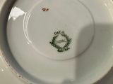 a white plate with a green and red design on it