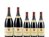 four bottles of red wine are lined up in a row