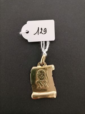 a gold plated necklace with a picture of a woman on it