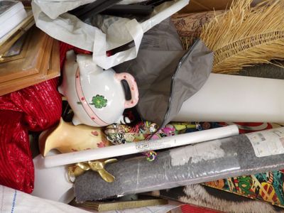 a pile of assorted items that include a teapot, a teapot, a brush, and other items