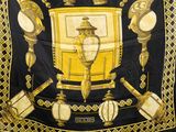 an image of a black and gold scarf with a picture of a lamp post