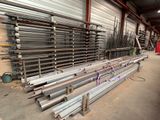 a large pile of steel pipes in a warehouse