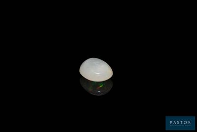 a close up of a white stone on a black surface