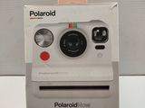 a polaroid camera sitting on top of a box
