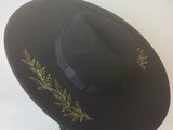black hat with gold embroidery on the brim of the brim of the brim of the brim of the brim of the brim of the br