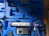 une mallette bleue contenant des outils, posée par terre