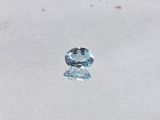 a close up of a blue topaz diamond on a white surface