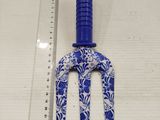 a close up of a plastic fork with a ruler in front of it