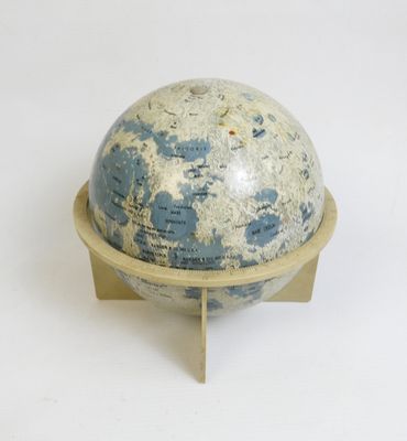 a small blue and white globe on a wooden stand