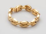 a gold bracelet with a braid design