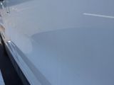 a white van that is parked on the side of the road