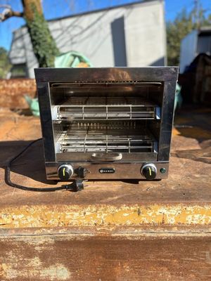 a toaster oven sitting on top of a piece of wood