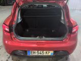 the back of a red car with its trunk open in a garage