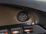 a close up of a clock on the dashboard of a car