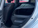a silver car with its door open in a parking lot