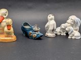 several figurines of dogs and cats are lined up on a table