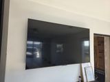 a flat screen tv mounted on the wall in the living room